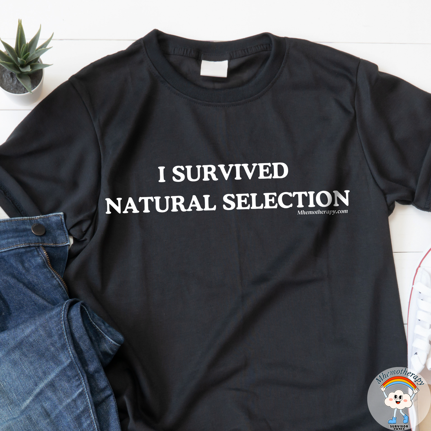 Close up of the black "I Survived Natual Selection" funny cancer t-shirt, chronic illness shirt, & spoonie tee from Mhemotherapy.